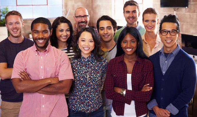 Portrait Of Staff Standing In Modern Design Office